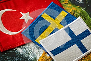 Turkish flag next to the flags of Finland and Sweden Concept of a political conflict between a member of the North Atlantic Pact