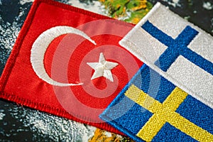 Turkish flag next to the flags of Finland and Sweden Concept of a political conflict between a member of the North Atlantic Pact