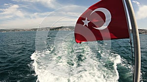 Turkish flag waving on the stern of an Istanbul Ship is Floating