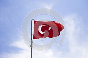 Turkish flag waving in the wind at blue sky