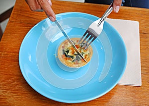 Turkish flat bread with cheese and spinach topping served on a plate.