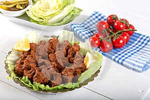 Turkish Food Cig Kofte with lemon, lettuce and parsley