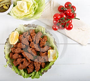 Turkish Food Cig Kofte with lemon, lettuce and parsley