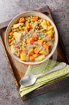 Turkish food Green Peas with Ground Beef stew Kiymali Bezelye closeup on the plate. Vertical top view