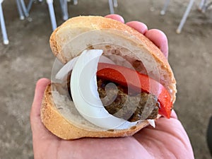 Turkish Food Kofte Ekmek / Meatball Sandwich with tomatoes and onion