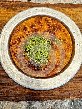 Arabian sweet during Ramadan.kanafeh traditional middle east Arabic food restaurant dessert on a white dish plate