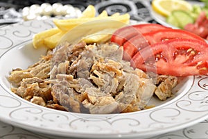 Turkish kebab with french fries and tomatoes