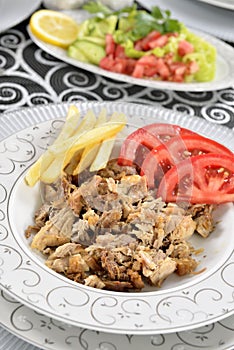 Turkish kebab with french fries and tomatoes
