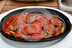 Turkish kofte with tomato sauce.