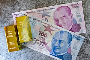 Turkish lira banknotes and golds on grey background