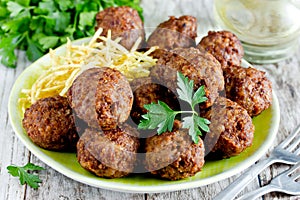 Turkish meatballs kuru kofte garnished with fried potato photo