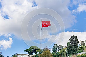 Turkish national flag and modern buildings along the Bosphorus strait in Istanbul Turkey from ferry on a sunny day with background