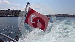 Turkish National flag waving in the wind at the Bosphorus in Istanbul in summer