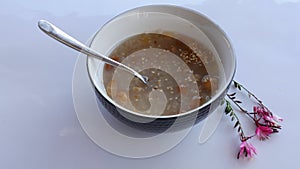 Turkish Noah`s Pudding or ashura served with bowl and spoon up.