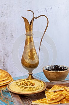Turkish party table with hummus, bread and copper jug