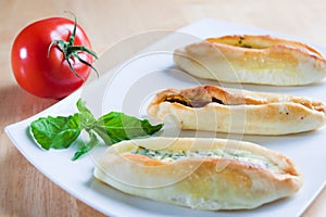 Turkish pide with basil leaves and tomato