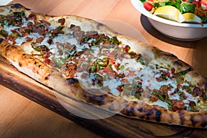 Turkish Pide with Minced Meat Kavurma Salad and Pickles.