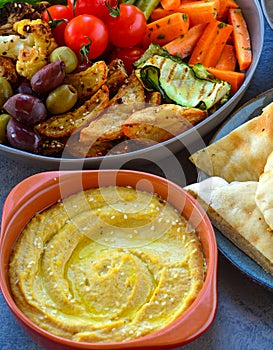 Turkish platter bowls of pita bread, hummus and grilled veggies