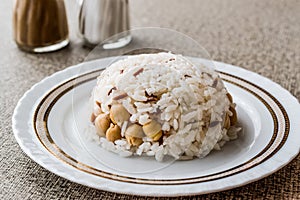 Turkish Rice with chickpea served with salt and pepper / Nohut Pilav. photo
