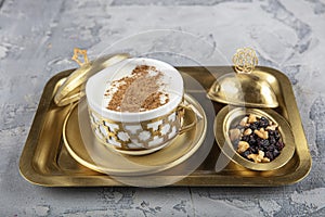 Turkish Salep in a copper tray set. Sahlep drink with cinnamon and ground pistachios. Sahlep is a deliciously comforting hot milky