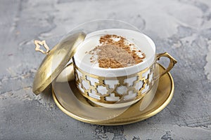 Turkish Salep in a copper tray set. Sahlep drink with cinnamon and ground pistachios. Sahlep is a deliciously comforting hot milky