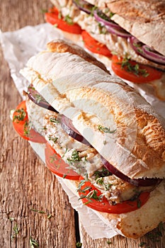 Turkish sandwich balik ekmek with fried mackerel close-up. vertical