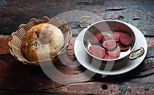 Turkish Sausage sucuk and bread roll on rustic wooden table
