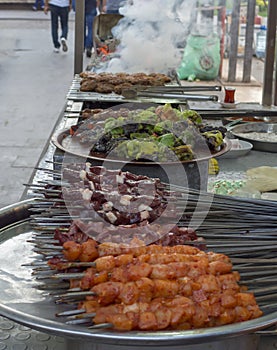 Turkish shish kebab on the street. liver, chicken, meatballs and pepper on the counter