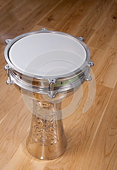 Turkish silver drum on a wooden floor