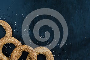 Turkish simit bagel dusted with sesame seeds on a black background