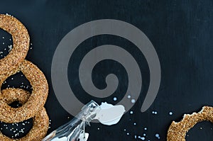 Turkish simit bagel and splashes of milk on a black background