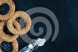 Turkish simit bagel and splashes of milk on a black background