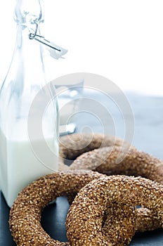 Turkish simit bagels and a bottle of milk on a black background
