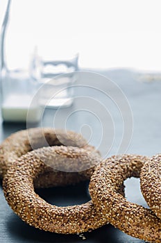 Turkish simit bagels and a bottle of milk on a black background