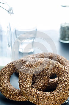 Turkish simit bagels and a bottle of milk on a black background