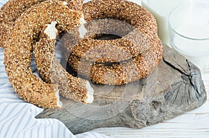 Turkish simit bagels and a bottle of milk on a wooden board