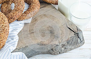 Turkish simit bagels and a bottle of milk on a wooden board