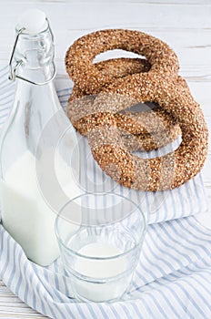 Turkish simit bagels and a bottle of milk on a wooden table