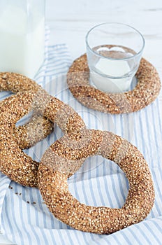 Turkish simit bagels and a bottle of milk on a wooden table