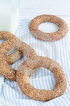 Turkish simit bagels and a bottle of milk on a wooden table