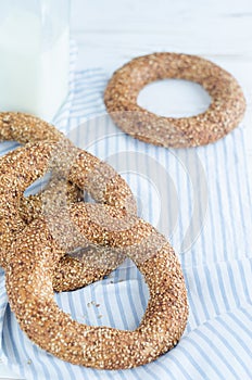 Turkish simit bagels and a bottle of milk on a wooden table