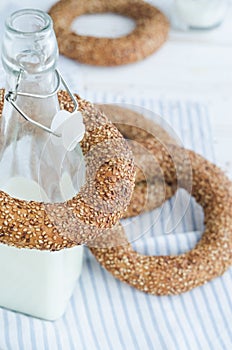 Turkish simit bagels and a bottle of milk on a wooden table