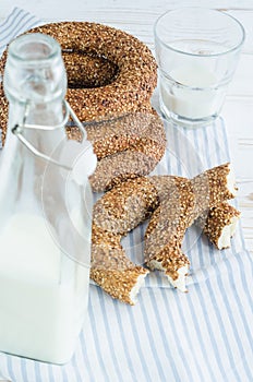 Turkish simit bagels and a bottle of milk on a wooden table