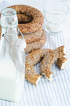 Turkish simit bagels and a bottle of milk on a wooden table