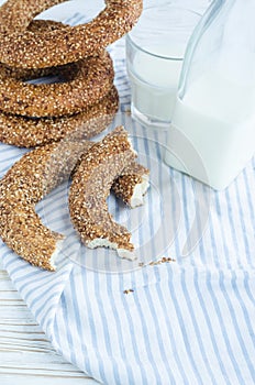 Turkish simit bagels and a bottle of milk on a wooden table