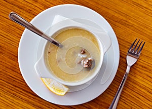 Turkish soup Paca corbasi served with lemon slice