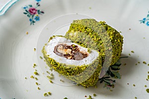 Turkish specific dessert muska pestil with pistachio powder and hazelnut chocolate cream . Amulet