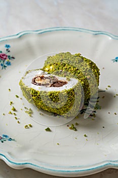 Turkish specific dessert muska pestil with pistachio powder and hazelnut chocolate cream . Amulet