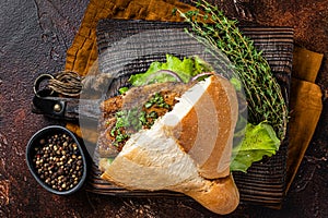 Turkish Street Food Balik Ekmek, fish sandwich with grilled mackerel fillet in a bun. Dark background. Top view