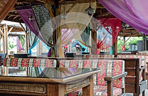 Turkish style design restaurant.  Outside terrace with colourful seats, curtains and mosaic lamps